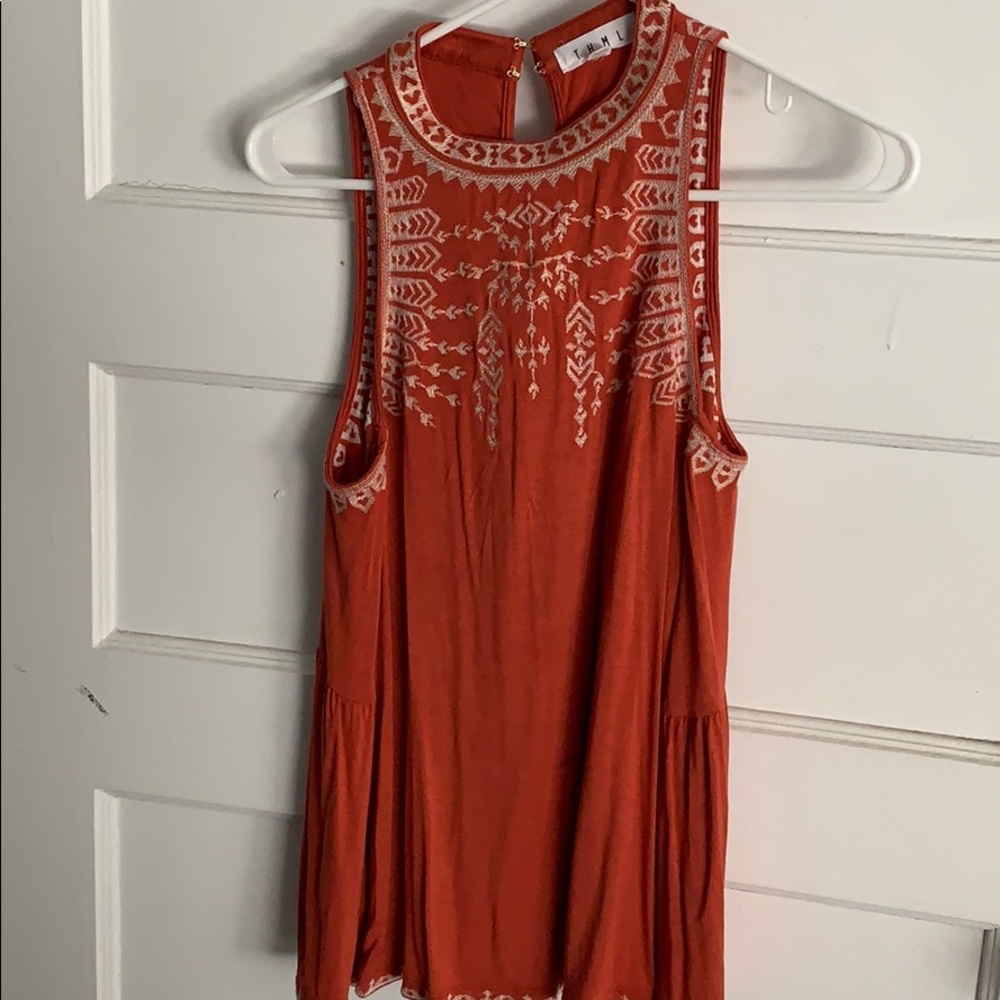 Orange tank top with white stitch detail
